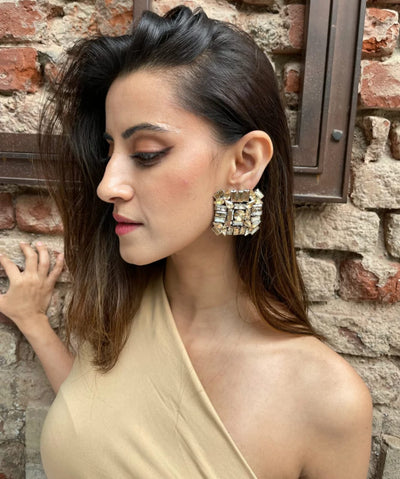 A lady wearning oversized zirconia studs in white color