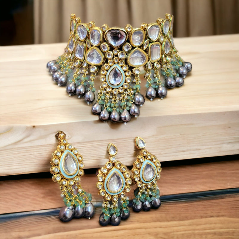 Akshara semi-precious necklace set with earring and mang tikka in gray mother of pearl drops on the wooden floor