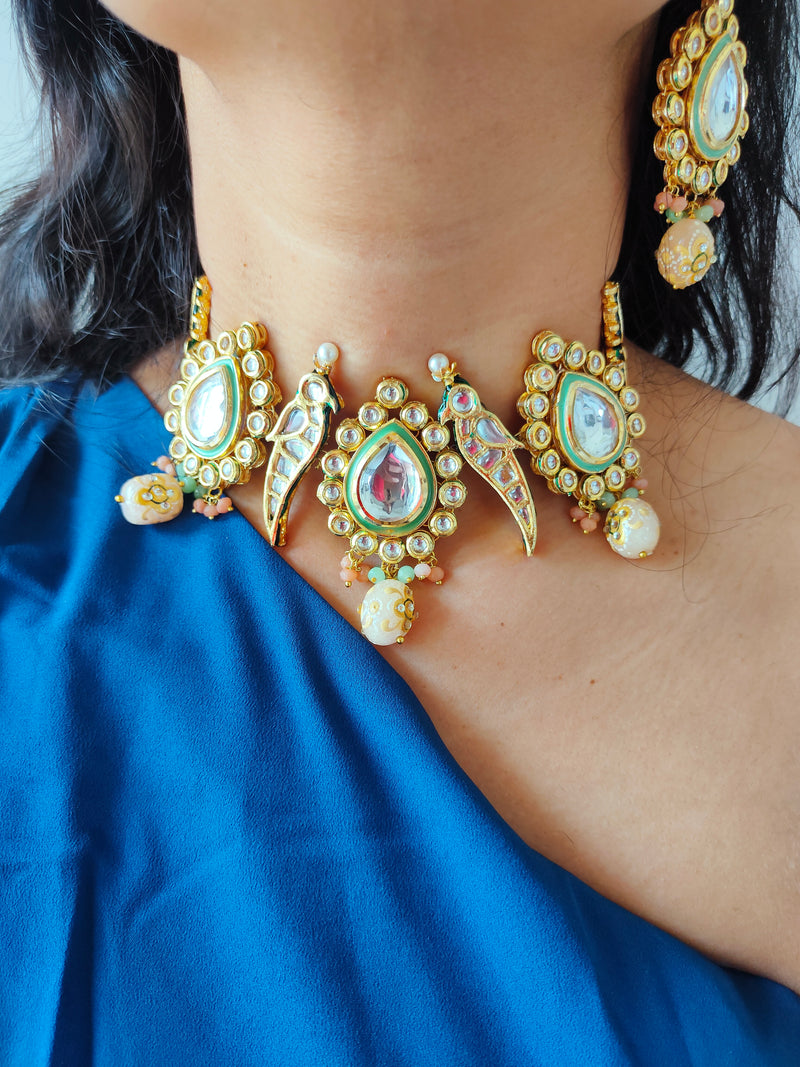A lady wearing parrot necklace with earrings