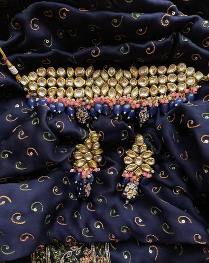 blue choker necklace with earrings on the blue saree